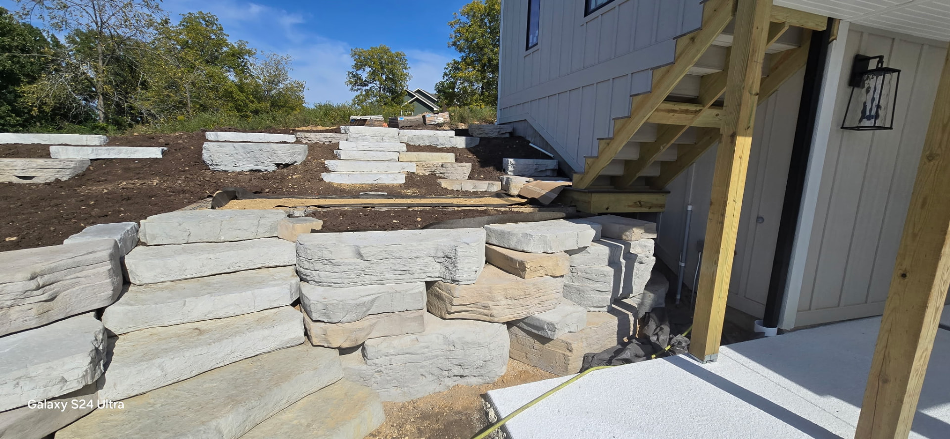 Armei crew's boulder step and wall installation in progress
